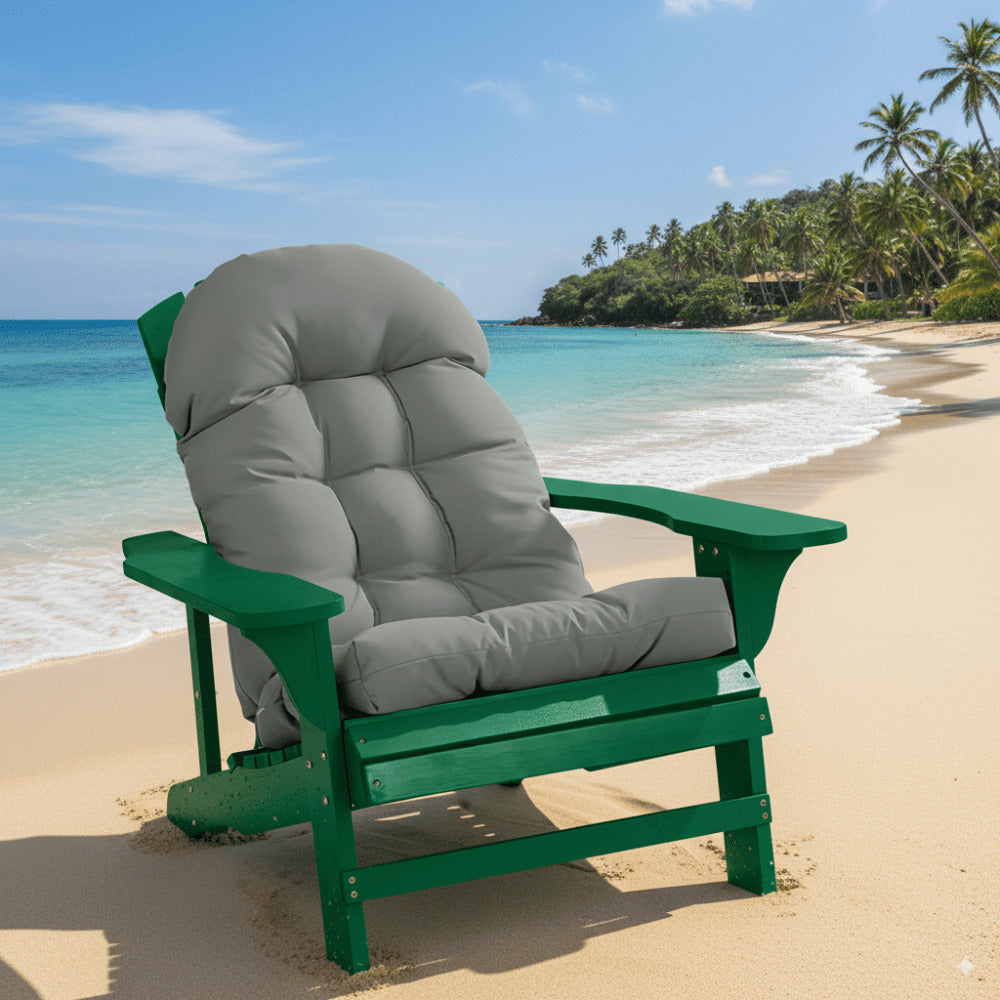 Green and gray chair on a sandy beach with ocean and palm trees in the background
