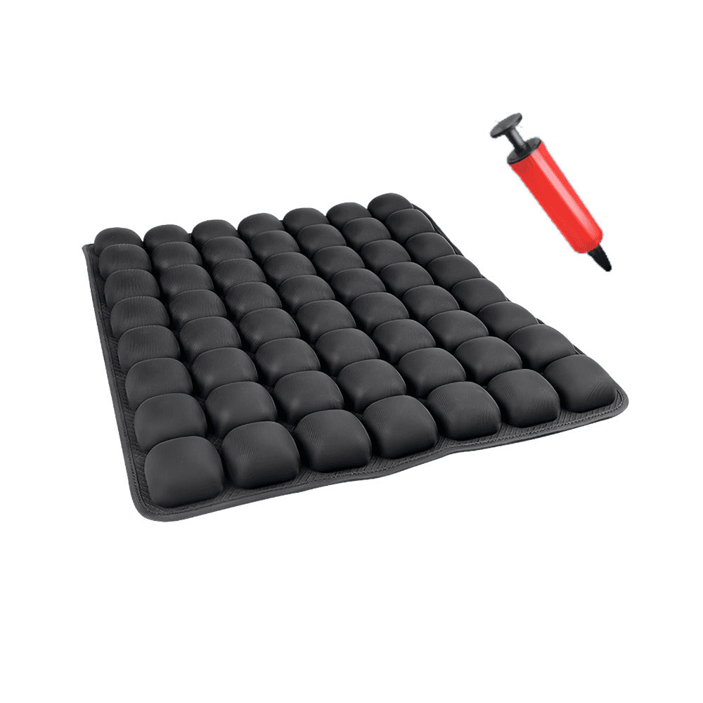Black silicone mold with small cavities and a red and black pump on a white background
