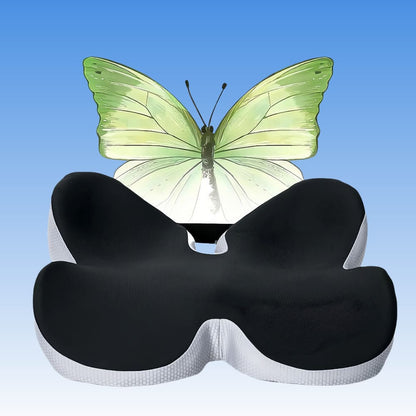 Black and white butterfly-shaped pillow with a green butterfly on a blue gradient background