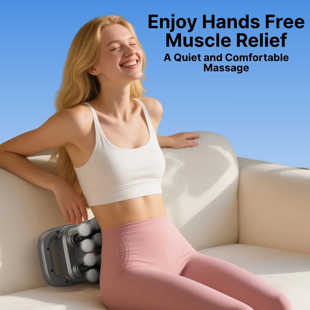 Woman sitting on a couch with a massage device, enjoying hands-free muscle relief.