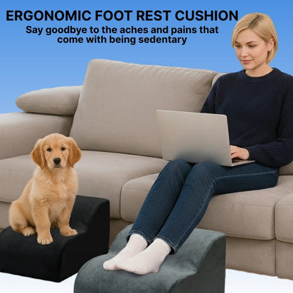 Woman using a laptop on a couch with a dog on a footrest, promoting an ergonomic foot rest cushion.