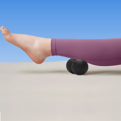 Person using a foam roller on a plain background