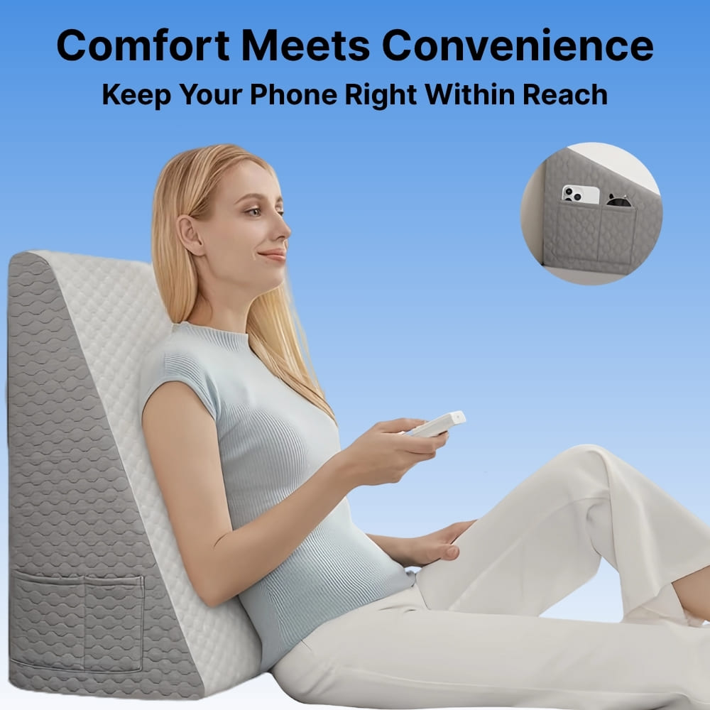 Woman sitting on a wedge-shaped pillow with a phone pocket, holding a phone.