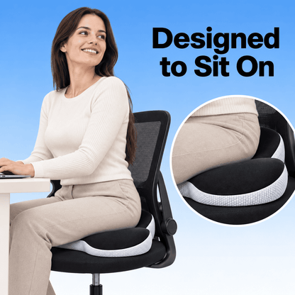 A woman sits on a black mesh office chair with a white and black contoured cushion pad, shown against a blue gradient background with the text 'Designed to Sit On' and a circular inset close-up of the cushion.