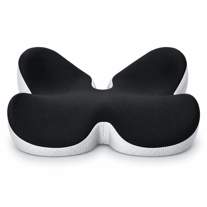 A butterfly-shaped ergonomic pillow with a black textured top surface and a white textured bottom base, shown on a clean white background.