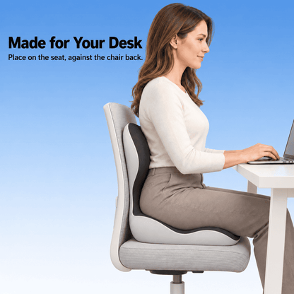 Woman using a black and light gray seat and back cushion on an office chair while working at a desk