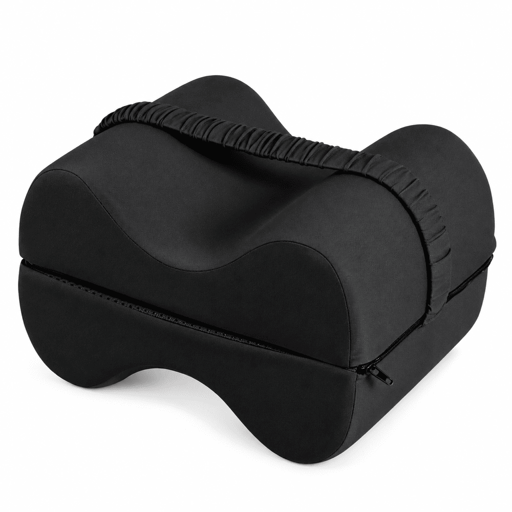 A black contoured lumbar support pillow with a zippered storage compartment and a gathered elastic strap, shown on a plain white background.