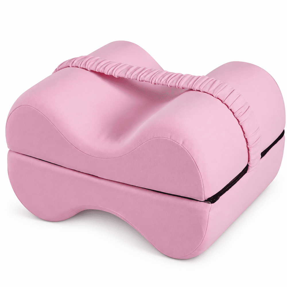 Pink contoured yoga support pillow with a textured fabric surface and a black accent line, shown on a clean white background.