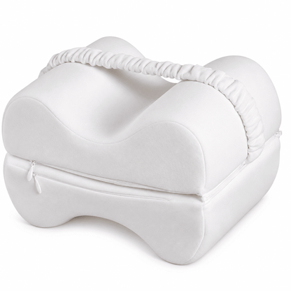 A white contoured baby support pillow with a zippered bottom and a gathered elastic carrying handle, shown on a clean white background.