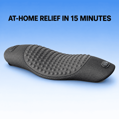 A dark gray textured relief cushion with a raised dotted massage surface, shown on a blue gradient background with the text 'AT-HOME RELIEF IN 15 MINUTES' at the top.