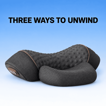 A dark gray massage pillow with a textured bubble backrest and contoured headrest, shown against a blue gradient background with the text 'THREE WAYS TO UNWIND' at the top.