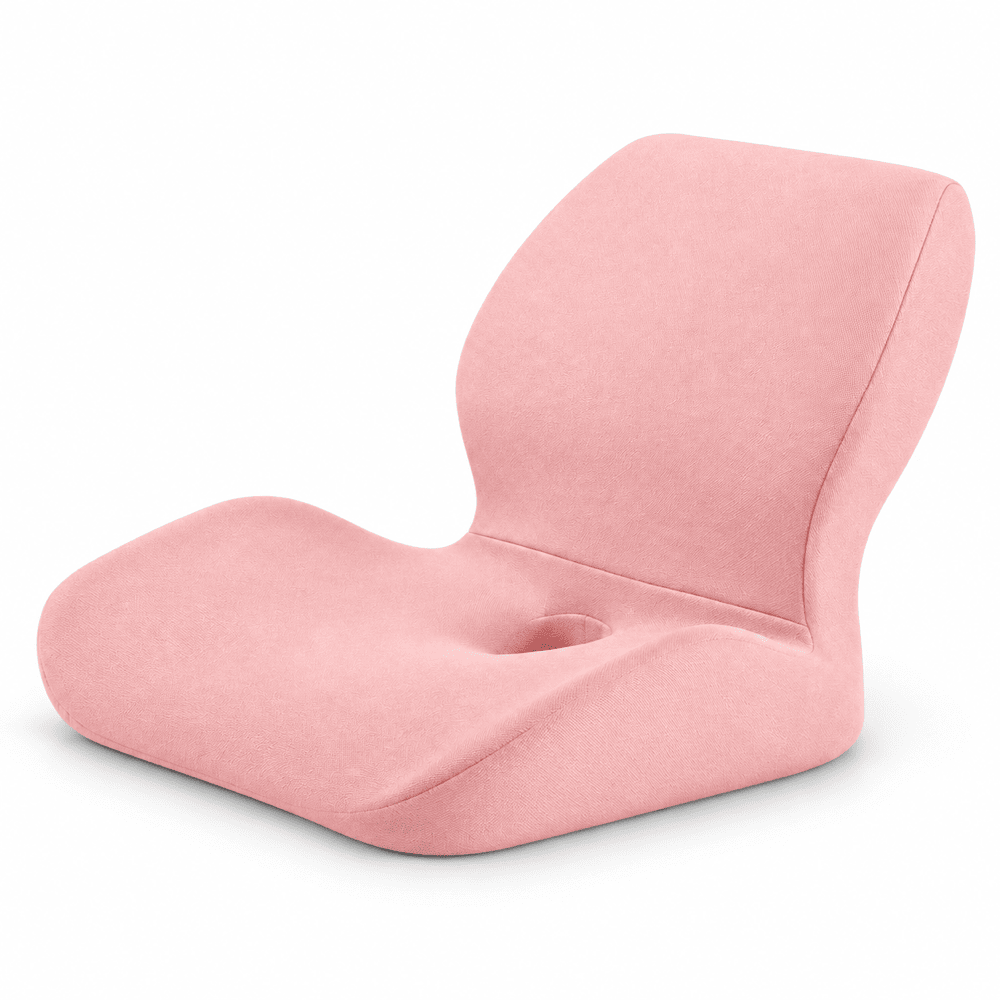 A pink contoured floor chair with a built-in cup holder in the center of the seat, shown on a clean white background.