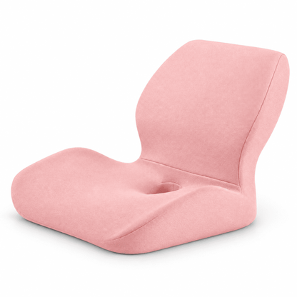 A pink contoured floor chair with a built-in cup holder in the center of the seat, shown on a clean white background.